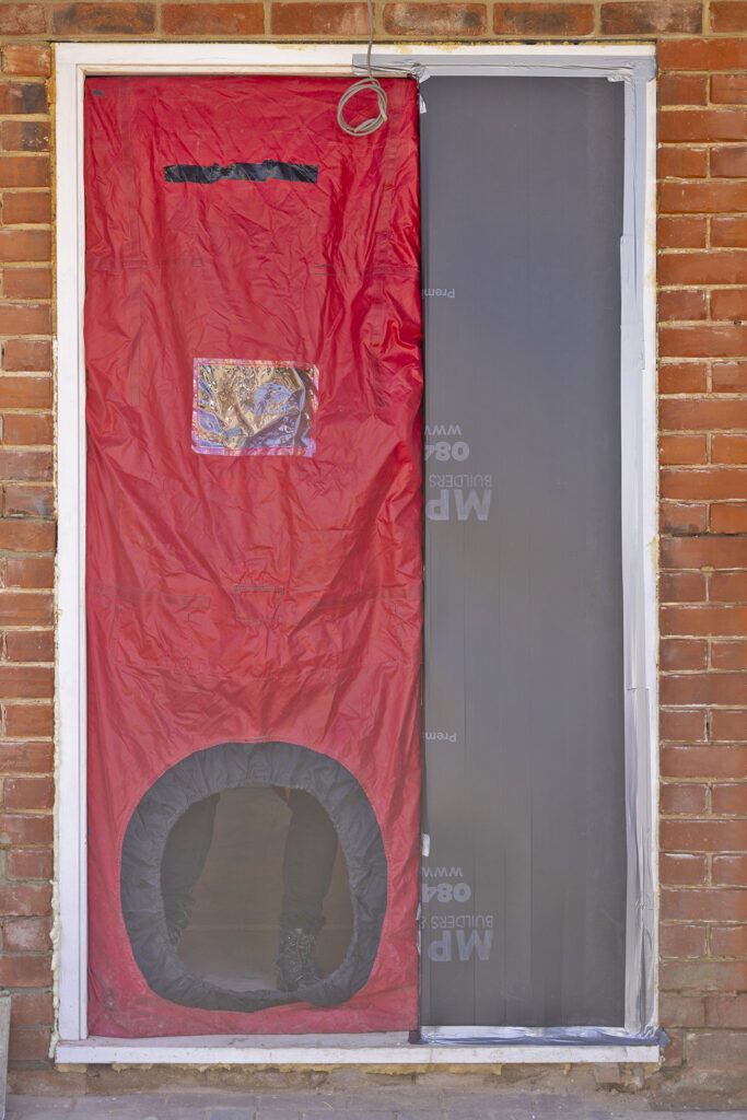 image of Blower Door Test being set up at our Red Brick House in Willesden, North West London to test airtightness