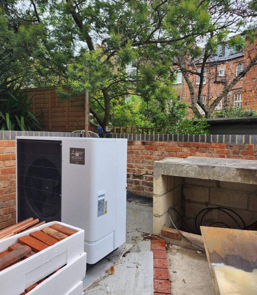 An Air Source Heat Pump will be installed in the rear patio with a cedar clad enclosure to conceal the unit