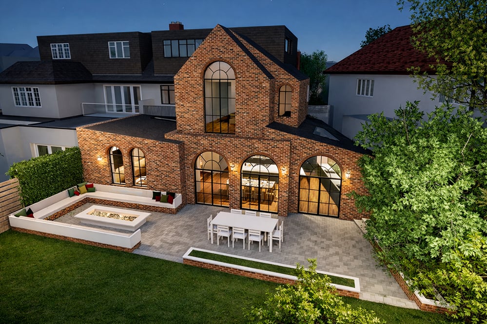 Aerial evening view of a two-storey brick extension in West Hampstead with arched glazing, outdoor dining terrace, and integrated garden design.