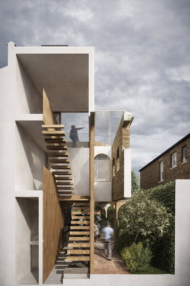 Architectural section of a London house extension showing open timber staircase, double-height space and arched structure, illustrating vertical connection and contemporary residential design.