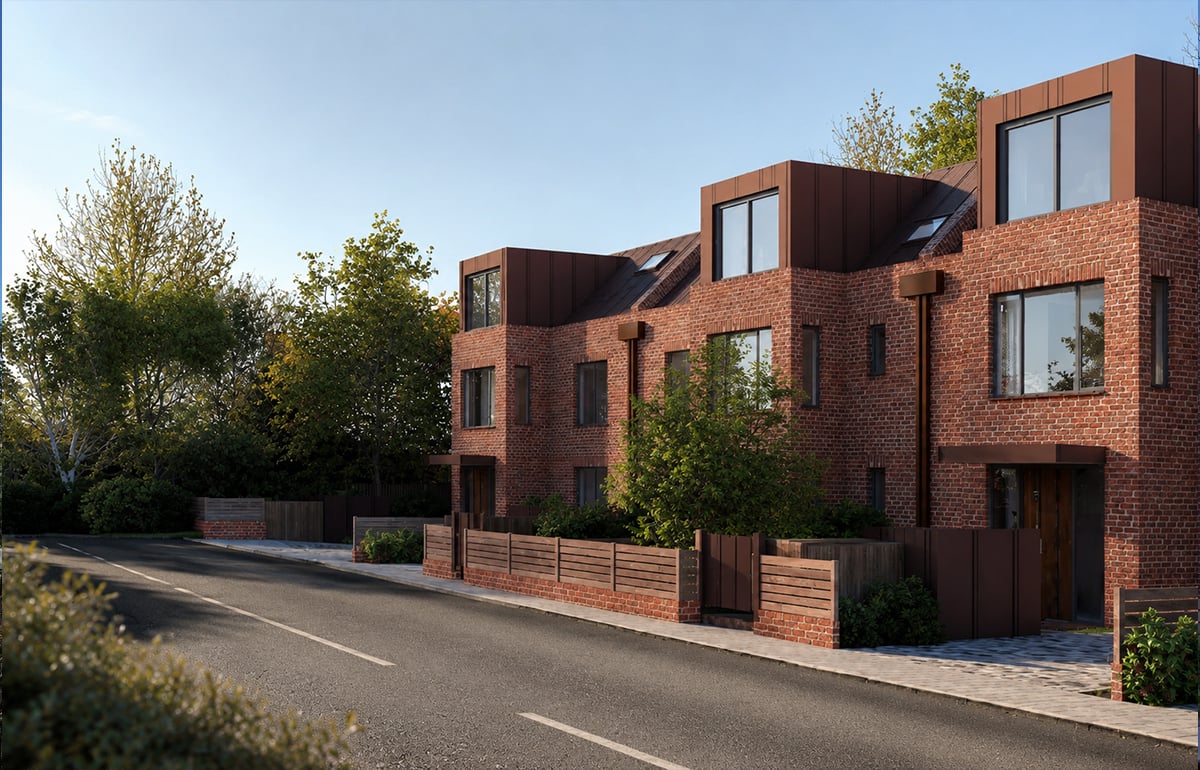 Developer-led residential scheme of contemporary brick townhouses with bronze standing-seam dormers and large dark-framed windows on a tree-lined London street, designed by RISE Design Studio