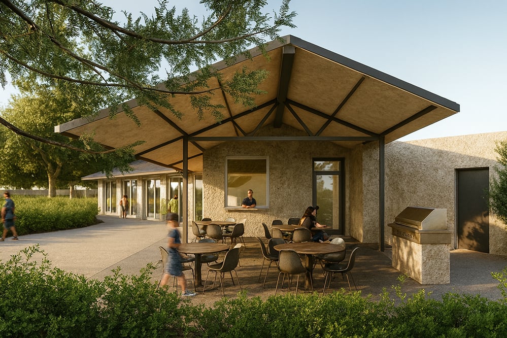 Outdoor terrace of the new Elmwood tennis clubhouse with wide canopy, hempcrete walls, serving hatch and shaded seating. Designed as a sustainable social space overlooking the club grounds.