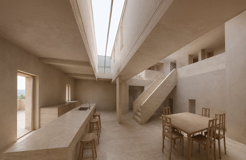 A calm, light-filled open-plan interior visualisation by RISE Design Studio, with monolithic lime-plaster and travertine surfaces, a long kitchen island with stools, a timber dining table, an open staircase and a linear rooflight drawing daylight down through the space toward a doorway onto a terrace.