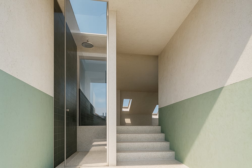 Interior view of the upgraded stair and bathroom area featuring a full-height lightwell, improved glazing and soft daylight, forming part of the sustainable low-energy retrofit to AECB standards in this Kensal Rise home.