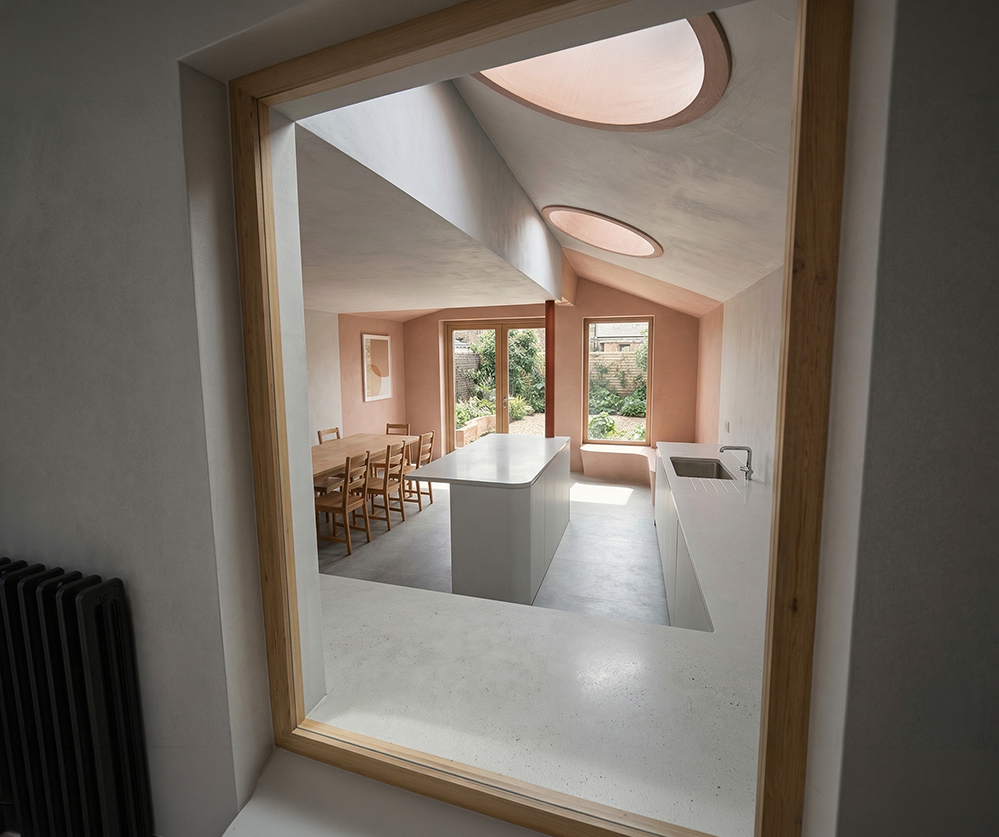 CGI visualisation of Scallop House kitchen-dining space, Winston Road Stoke Newington. Terracotta render, stone island, elliptical rooflight and garden views. Low-energy extension by RISE Design Studio.