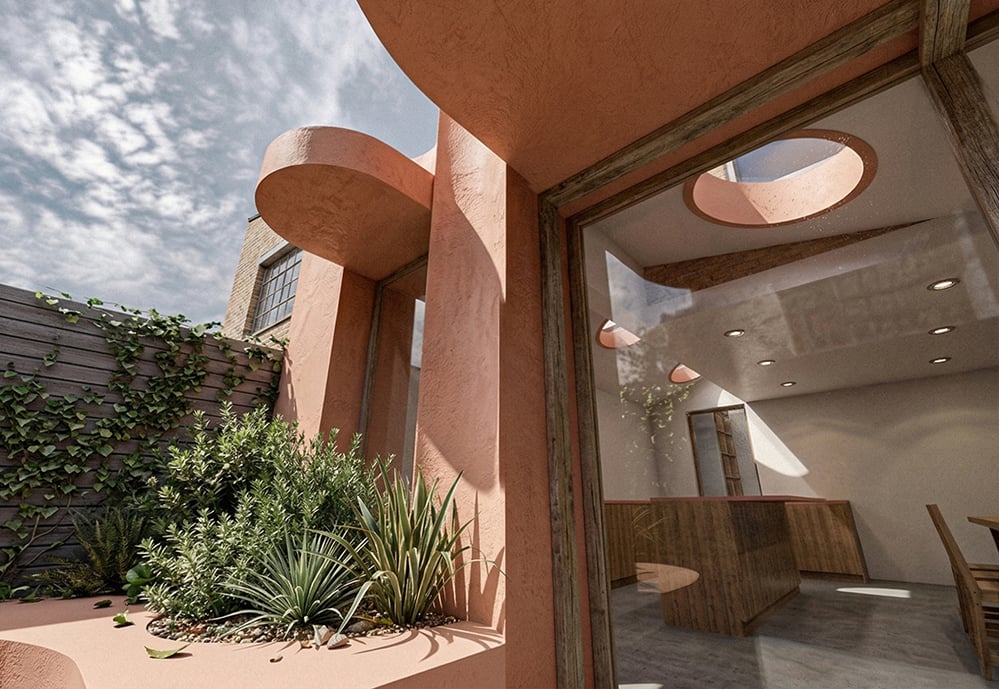 View through cylindrical pink render forms of Scallop House into kitchen and dining interior, Stoke Newington. Shadow and light play across the sculpted facade. RISE Design Studio