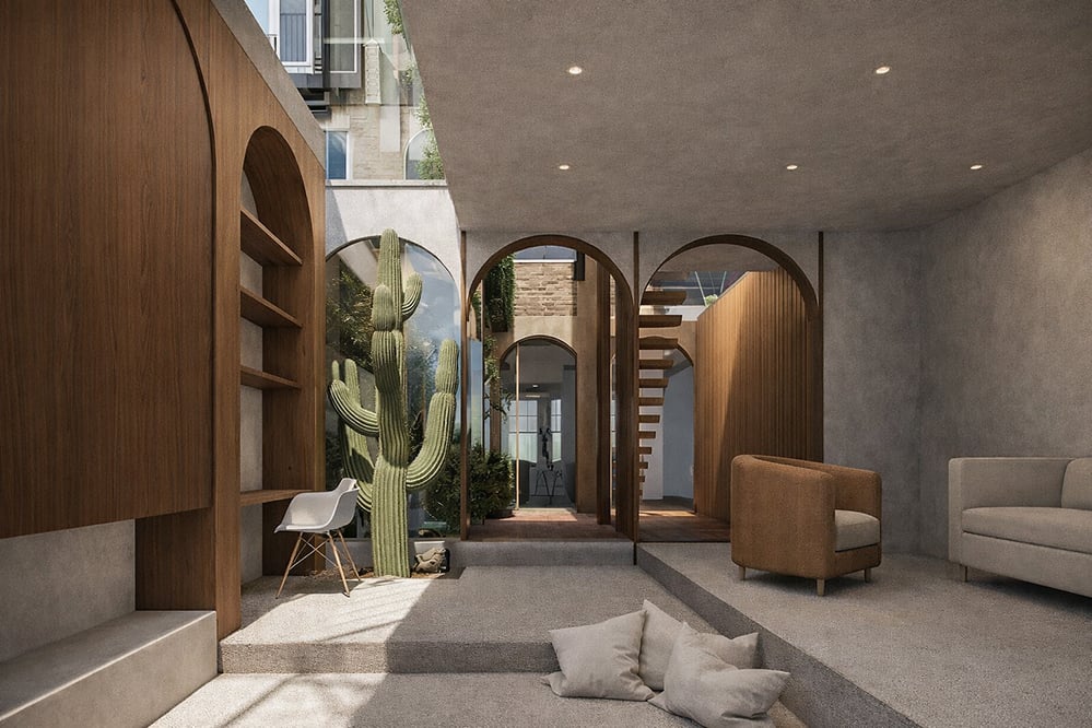Interior courtyard with cactus planting and arched openings in a modern London home, combining timber joinery, natural light and biophilic design principles to enhance wellbeing and spatial connection.