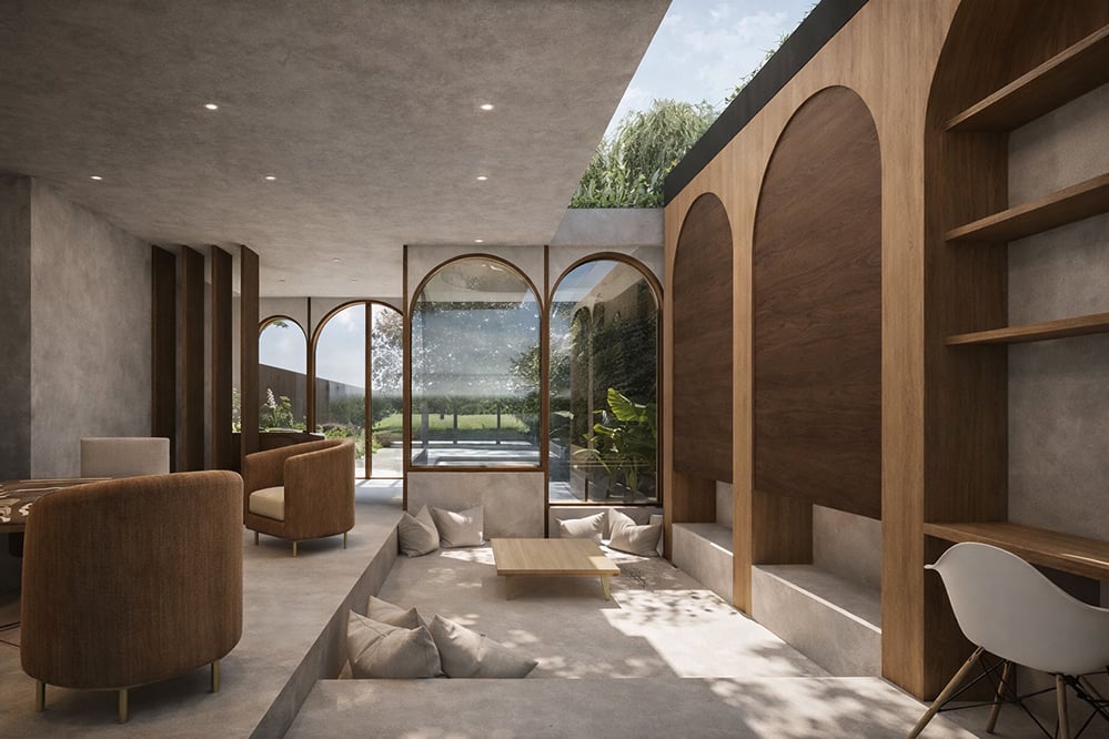 Sunken seating area in a contemporary London home extension with arched timber-framed glazing, polished concrete floor and soft natural light, connecting interior living space to garden in a low-energy residential design.