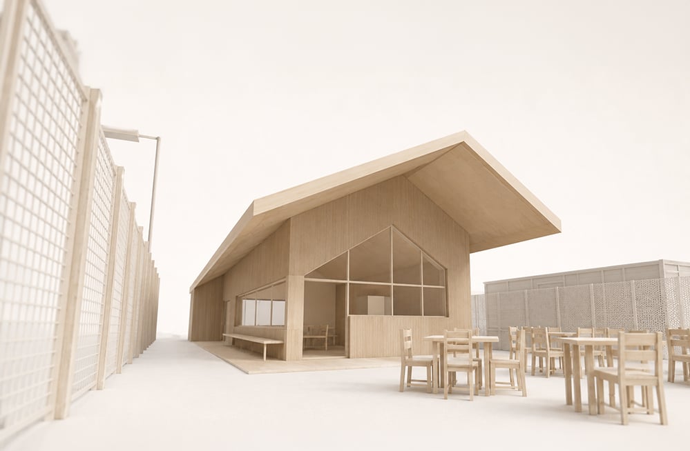 Plain timber-coloured architectural study model of a tennis clubhouse with a sweeping pitched roof, a tall glazed gable opening, an internal bench and a covered terrace with tables and chairs. A latticed court fence runs along the left. RISE Design Studio.