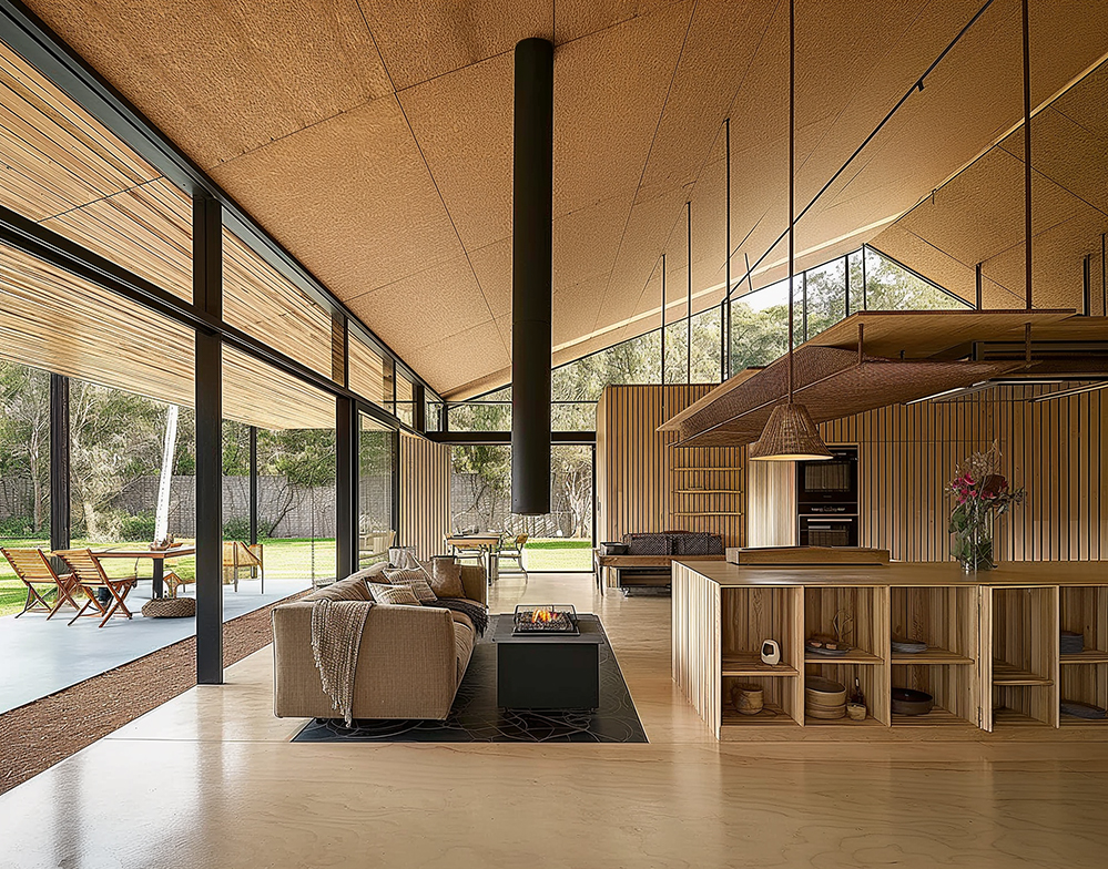 Interior view of a sustainable, open-plan living space designed with Passivhaus principles, featuring natural timber finishes, high-performance glazing, a suspended fireplace, and seamless indoor-outdoor connection for energy-efficient, low-carbon living.