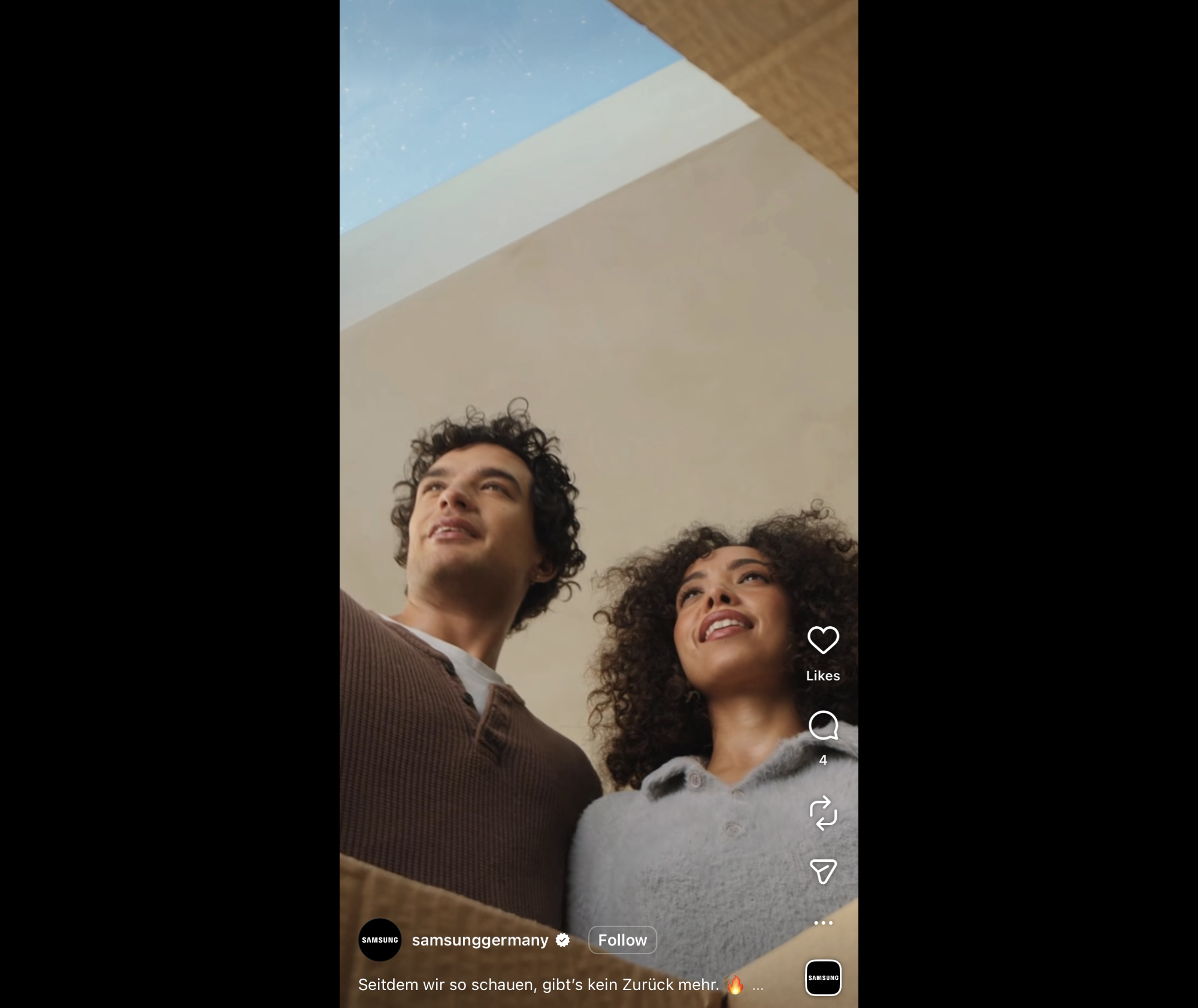 Still from Samsung Germany Instagram campaign filmed at Herbert Paradise Kensal Rise by RISE Design Studio, showing two people looking upward in a calm, warmly lit interior with natural daylight from above.