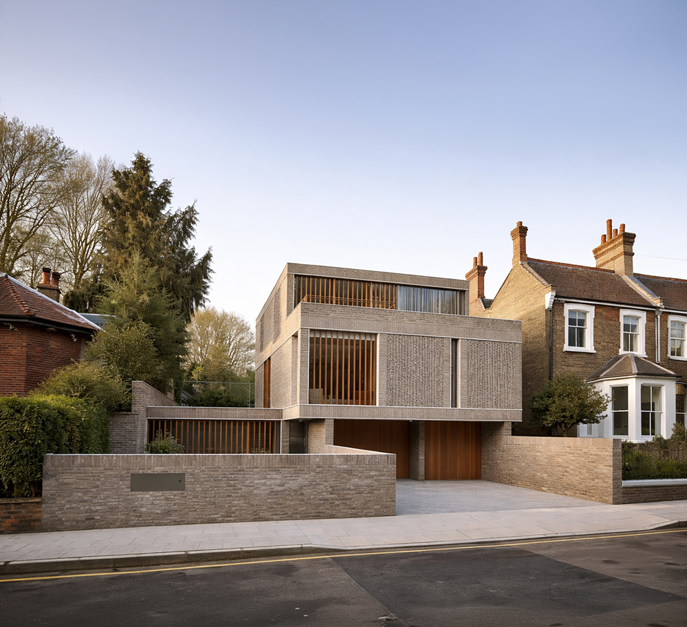 Hampstead House new build replacement dwelling North London, grey brick facade with vertical timber battens, contemporary house between period neighbours, street elevation at dusk.