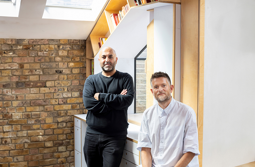 Colour photo of Sean Ronnie Hill and Imran Jahn, Directors of RISE Design Studio, in their London studio. The image reflects RISE’s ethos of sustainable architecture, transparent architects’ fees, and a commitment to design that adds value and creates lasting impact.