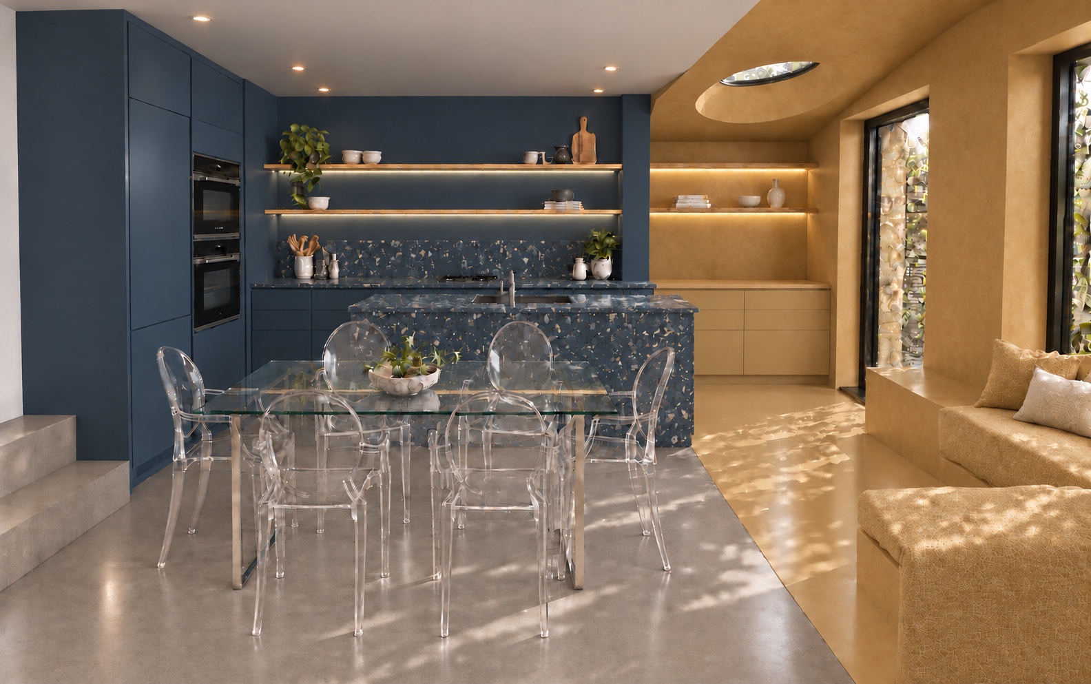 Scallop House kitchen concept with indigo cabinetry and a patterned island beside an ochre extension, with a glass dining table and transparent chairs in front.
