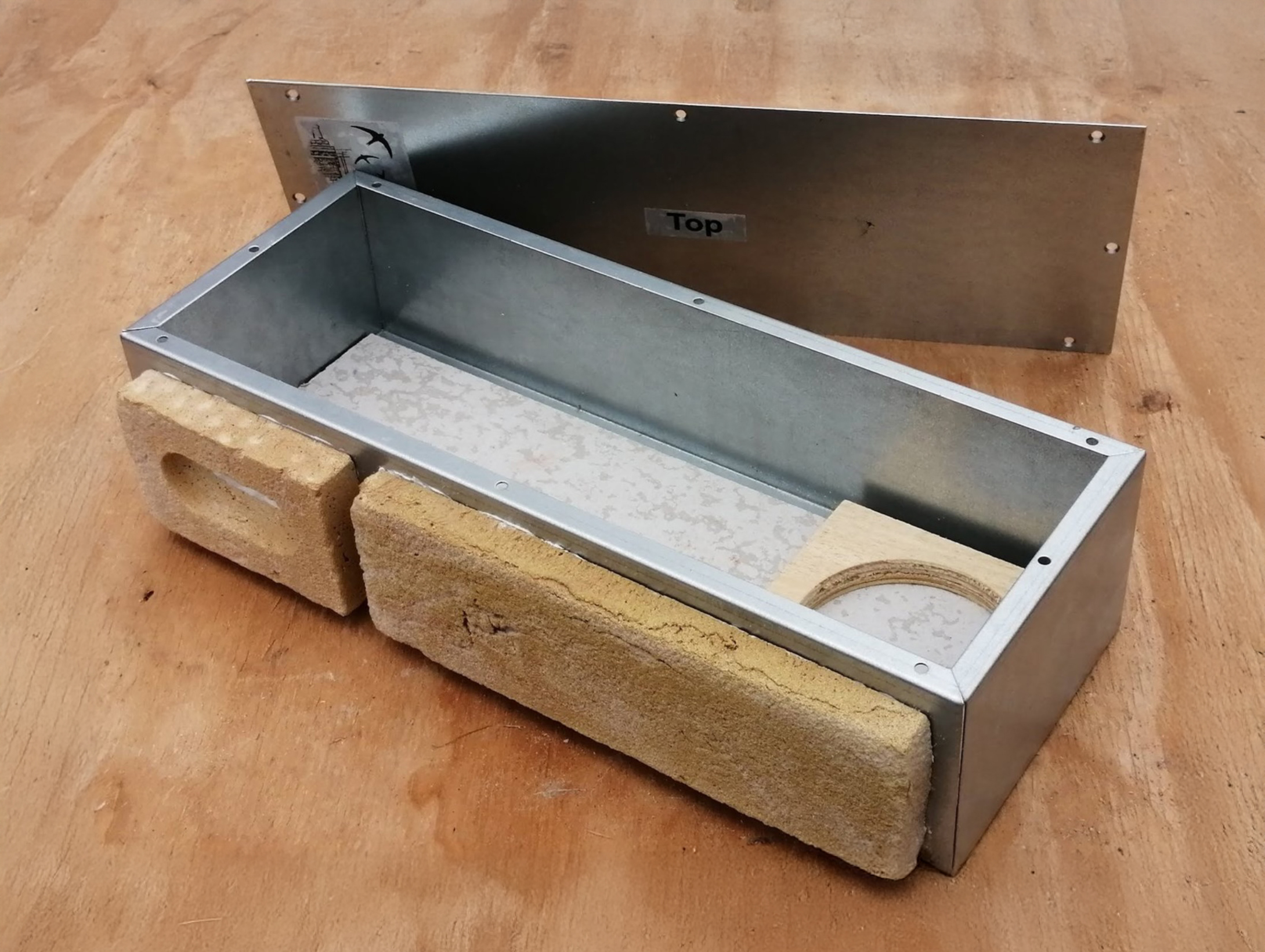 Built-in swift nest brick with removable cover, designed for seamless integration into external walls. Provides a safe, sustainable nesting site for swifts and other cavity-nesting birds as part of eco-conscious architectural design by RISE Design Studio.